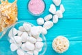 Sea Ã¢â¬â¹Ã¢â¬â¹salt in a glass white stones and Shell for spa and relaxation on a blue background Royalty Free Stock Photo